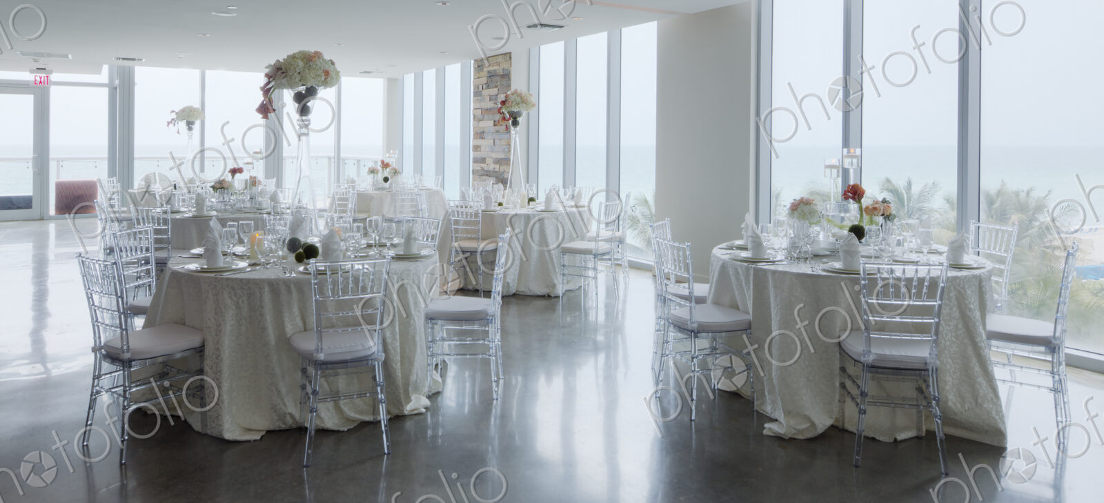 Empty tables in airy room with tables set for a wedding banquet
