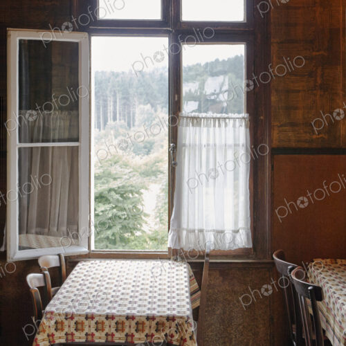 Empty tables near open window in cafe