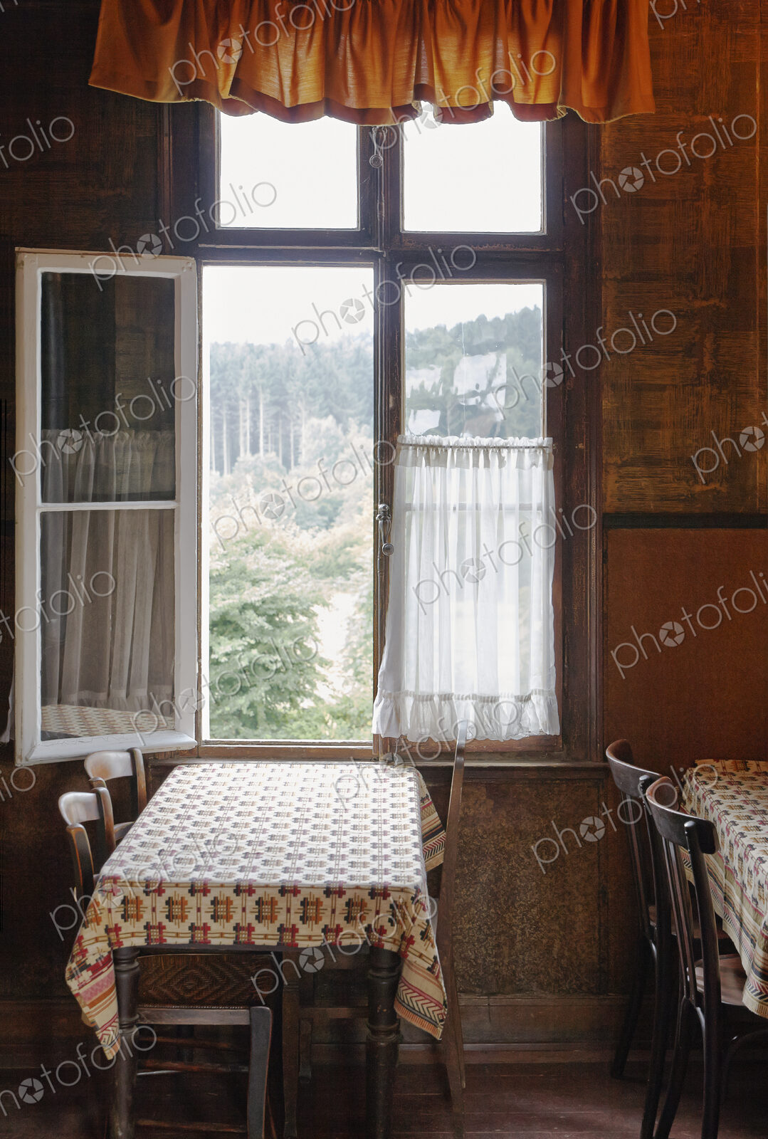 Empty tables near open window in cafe
