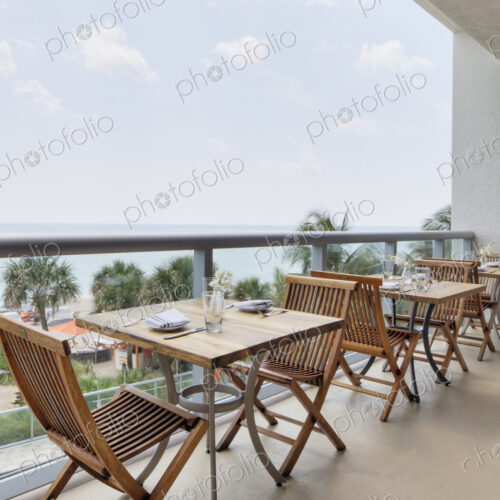 Empty tables on restaurant balcony Empty tables on restaurant balcony