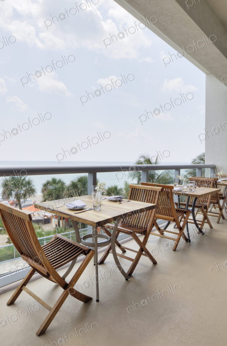 Empty tables on restaurant balcony