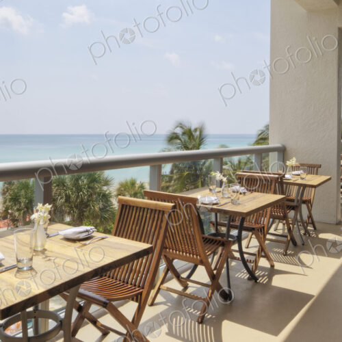 Empty tables on restaurant balcony Empty tables on restaurant balcony