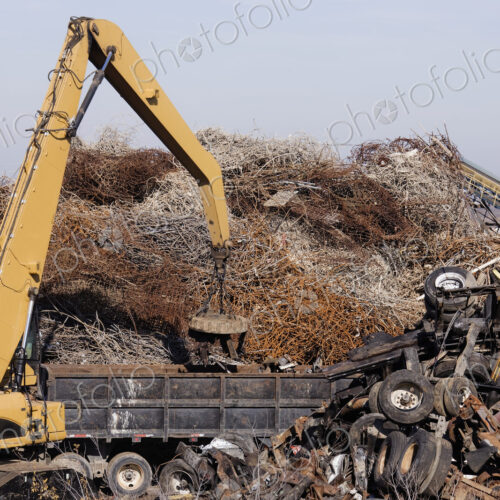 Excavator Moving Scrap Metal with Electro Magnet