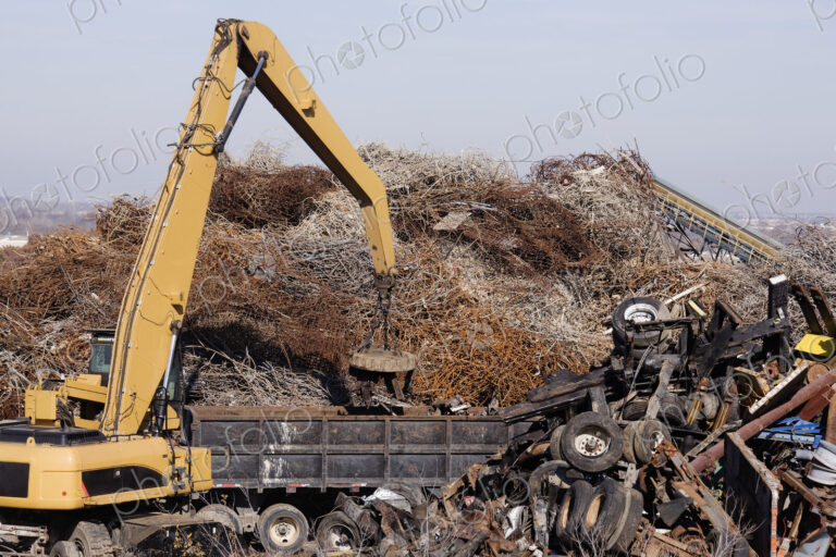 Excavator Moving Scrap Metal with Electro Magnet