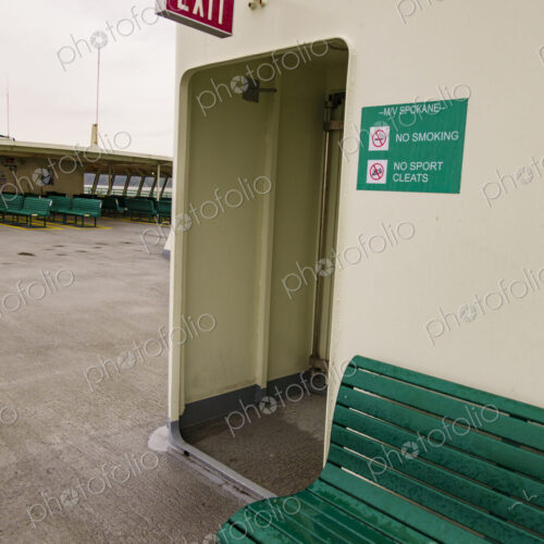 Exit sign and bench, Puget Sound ferry crossing from Edmonds to Kingston, WA USA Exit sign and bench, Puget Sound ferry crossing from Edmonds to Kingston, WA USA