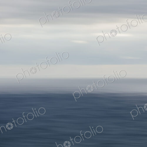 Expansive view of ocean, horizon and clearing storm clouds, dusk Expansive view of ocean, horizon and clearing storm clouds, dusk