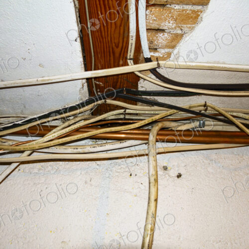 Exposed home electrical wires in basement. Exposed home electrical wires in basement.