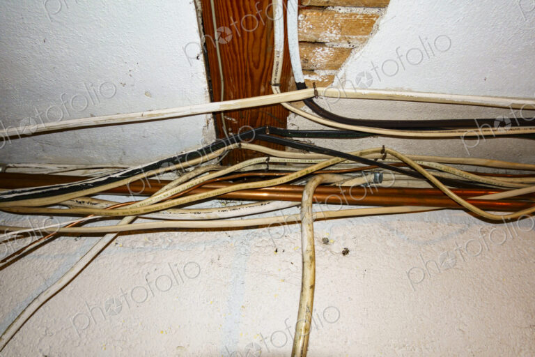 Exposed home electrical wires in basement.