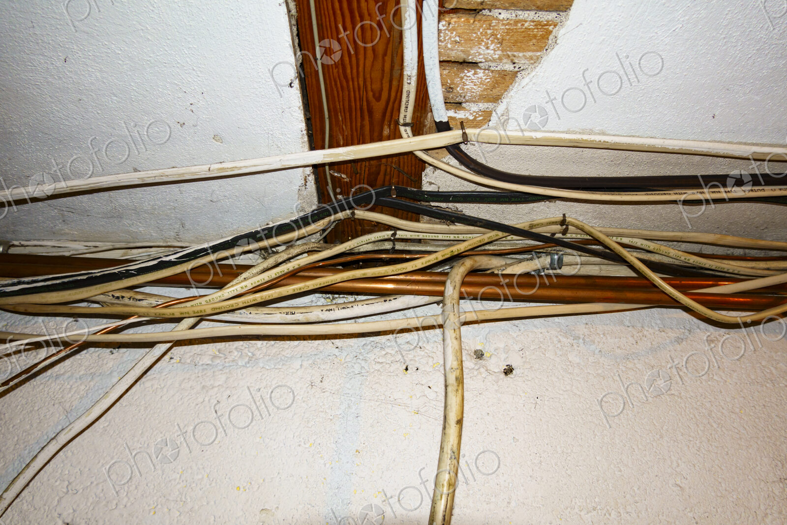 Exposed home electrical wires in basement.