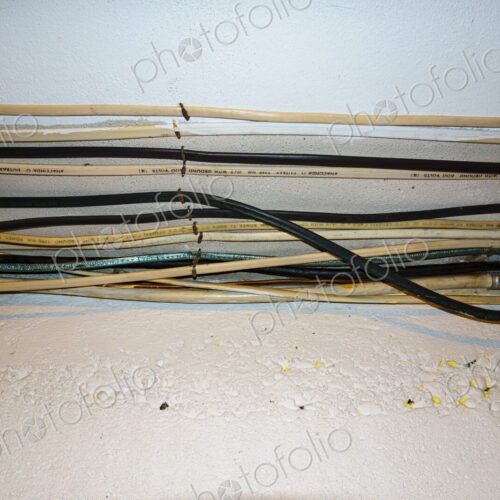 Exposed home electrical wires in basement. Exposed home electrical wires in basement.