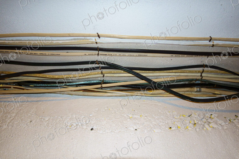 Exposed home electrical wires in basement.