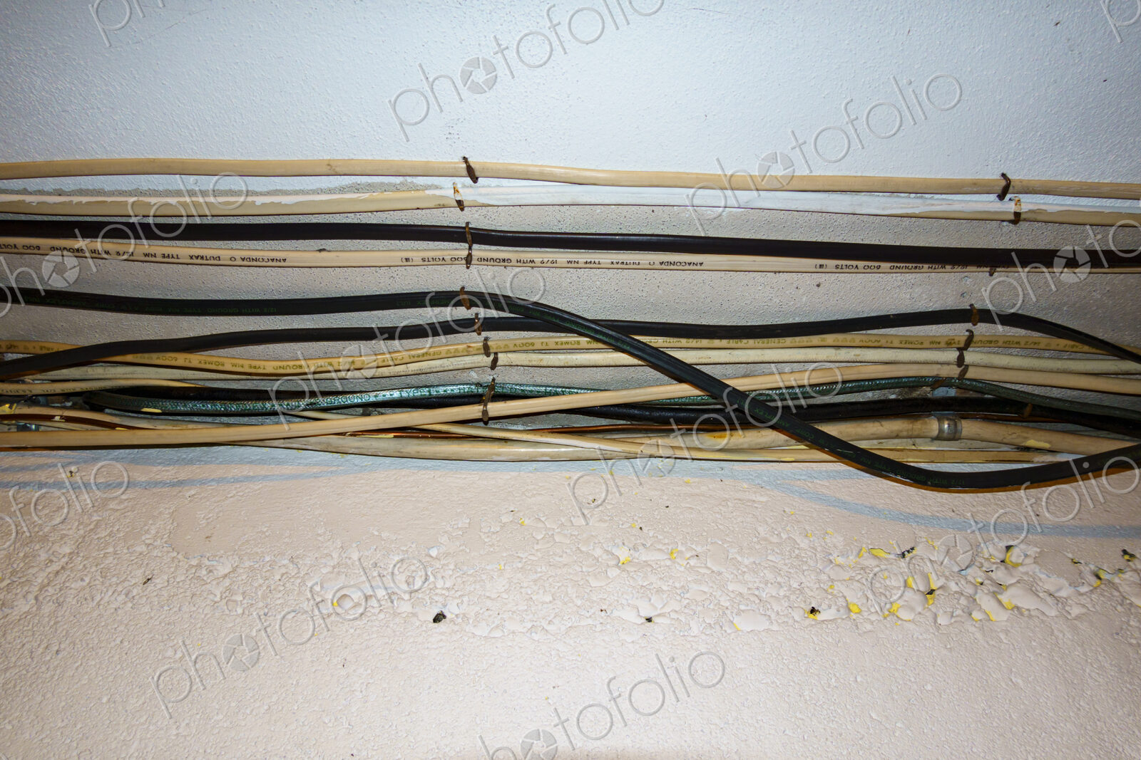 Exposed home electrical wires in basement.