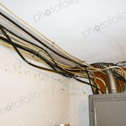 Exposed home electrical wires in basement. Exposed home electrical wires in basement.
