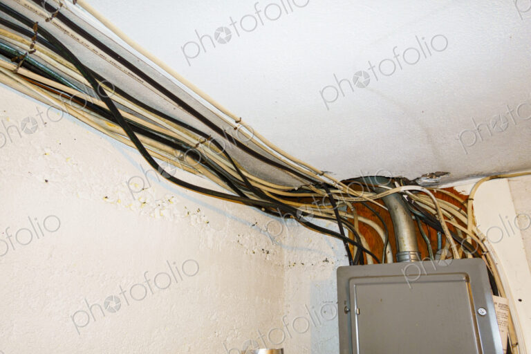 Exposed home electrical wires in basement.