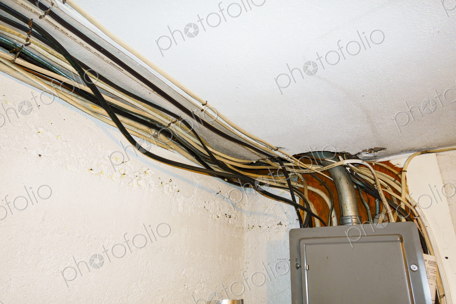 Exposed home electrical wires in basement.