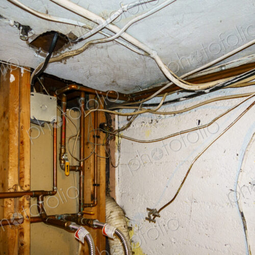 Exposed home electrical wires in basement. Exposed home electrical wires in basement.