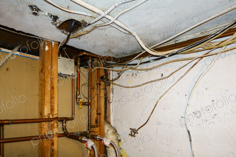Exposed home electrical wires in basement.