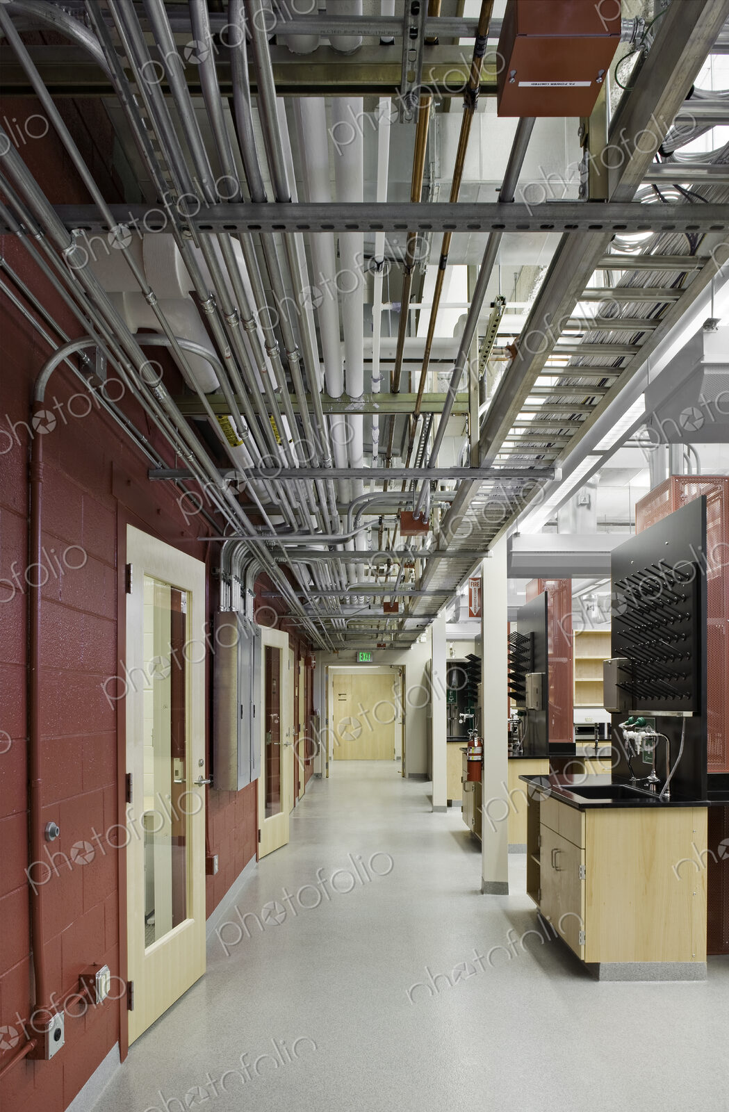 Exposed pipes in laboratory corridor