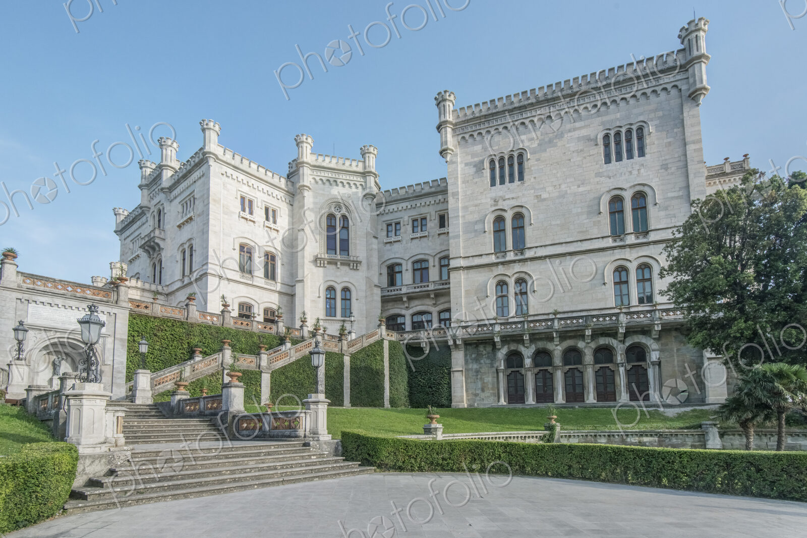 Exterior of Miramare Castle with lawns and steps, Trieste, Italy.