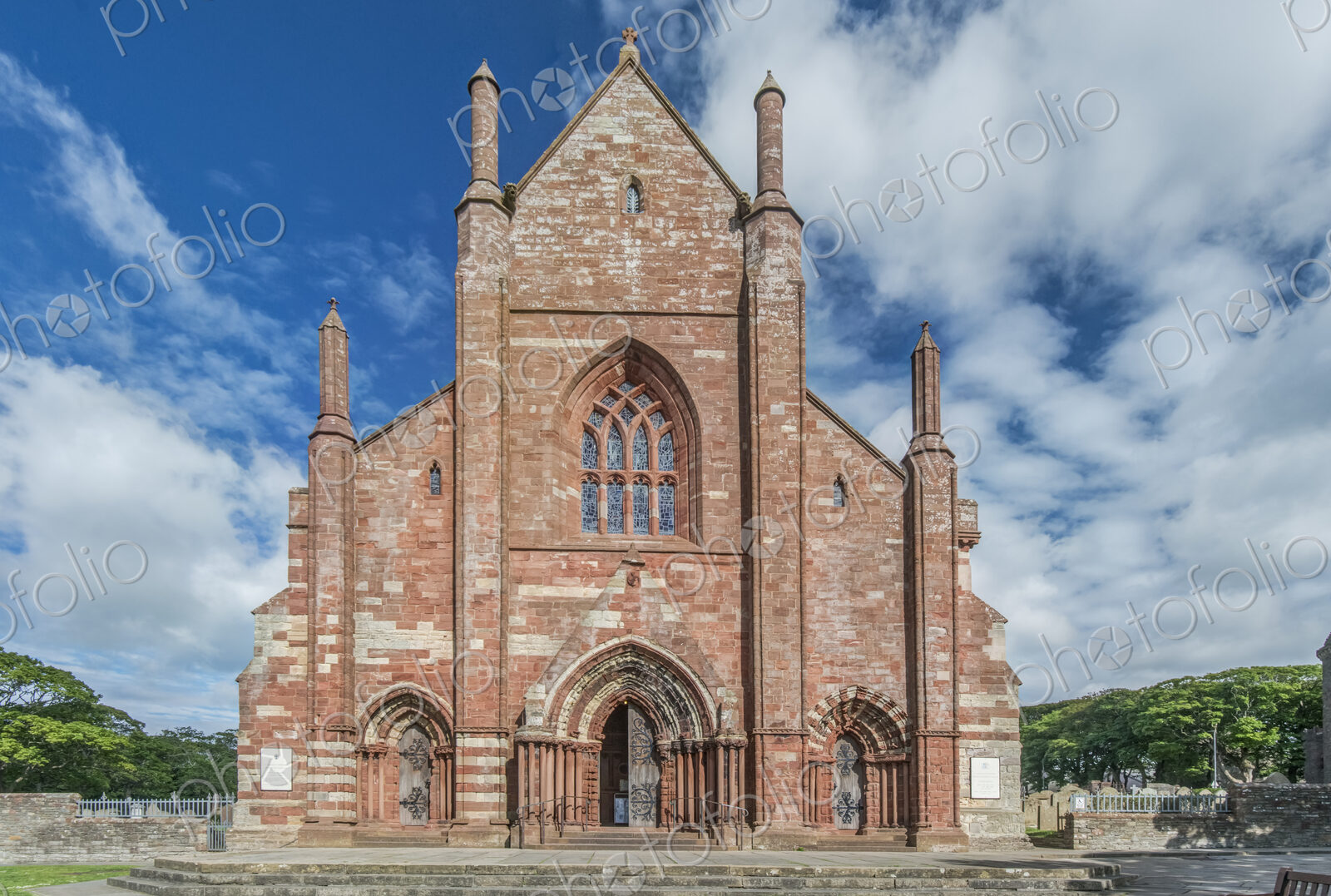 Exterior of St Magnus Cathedral, ornate red sandstone church.