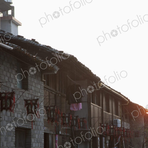 Exterior of village houses at sunset.