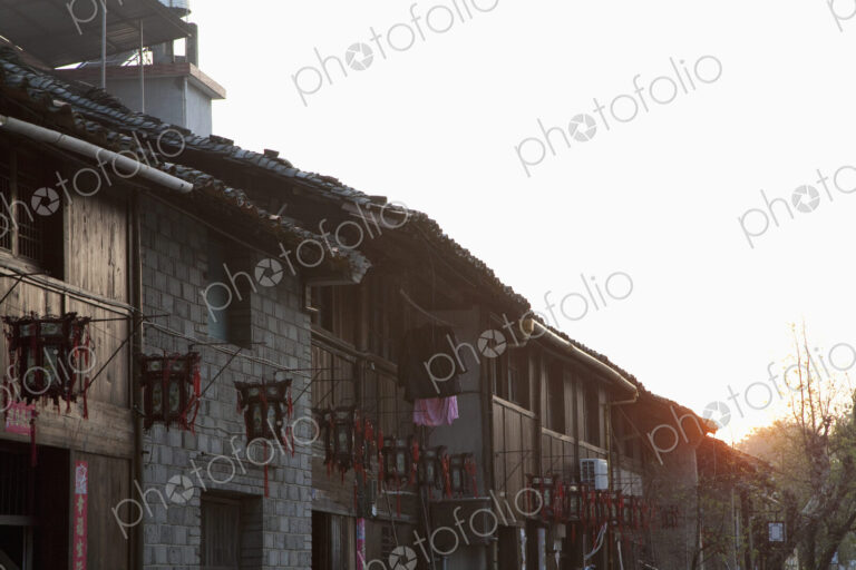 Exterior of village houses at sunset.