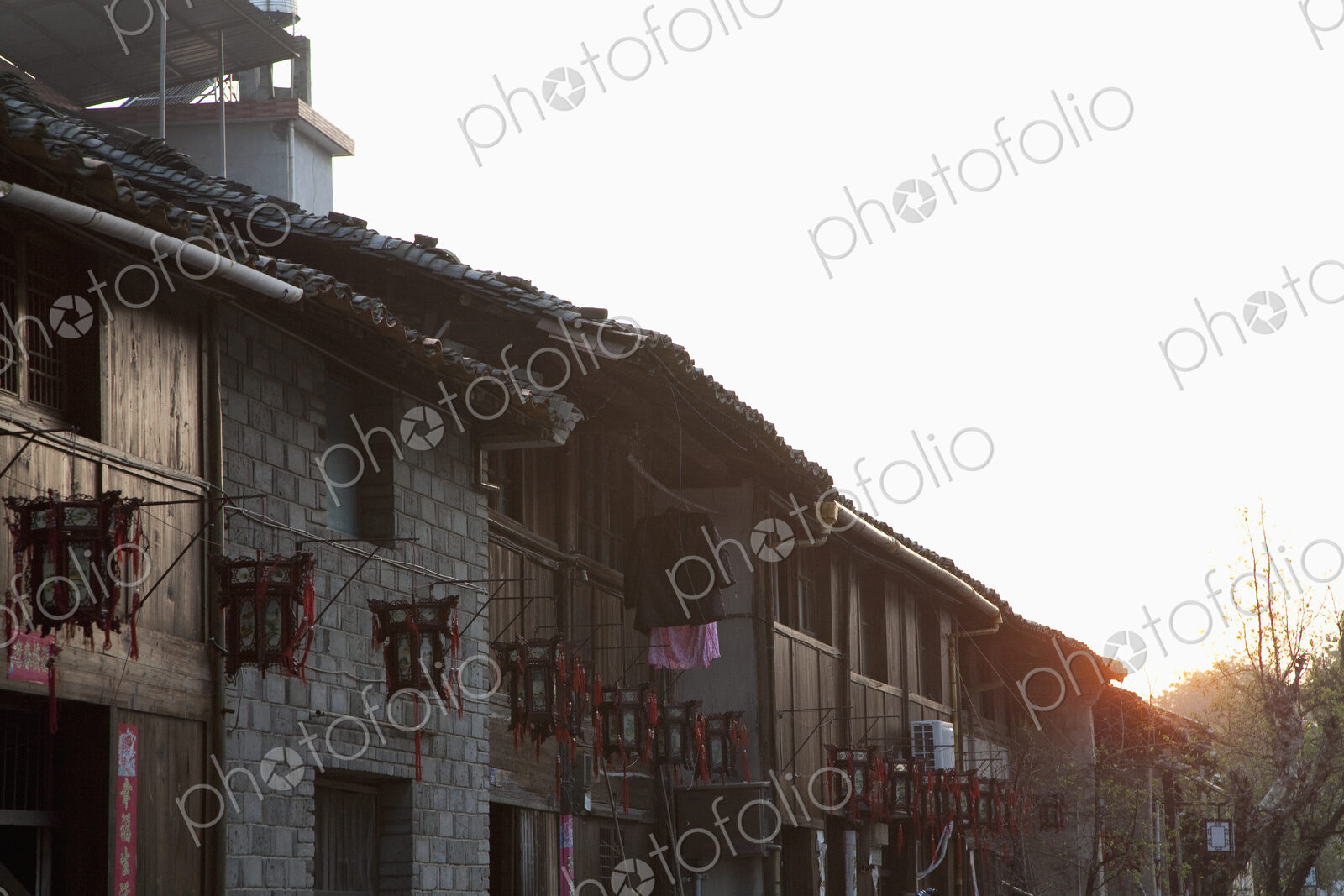 Exterior of village houses at sunset.