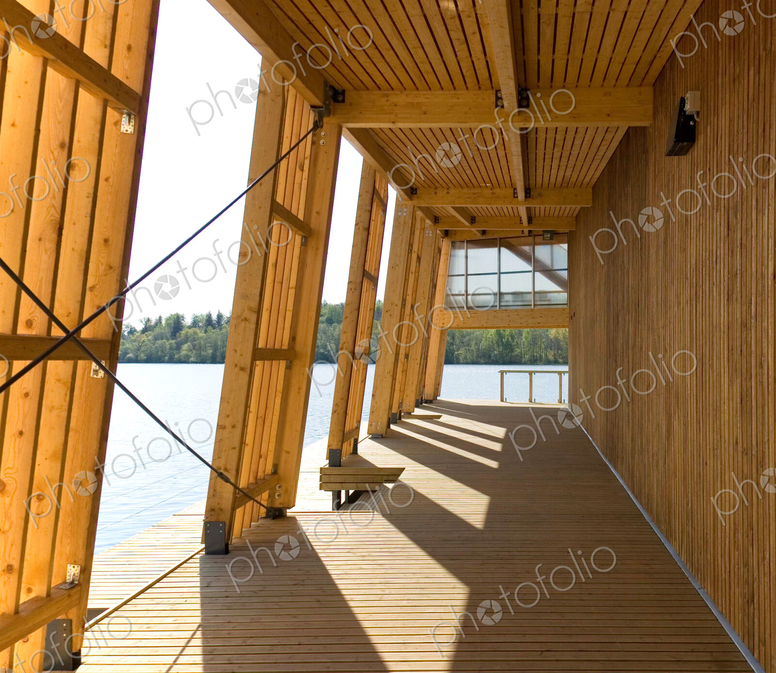 Exterior porch of wooden boathouse on river or waterfront.