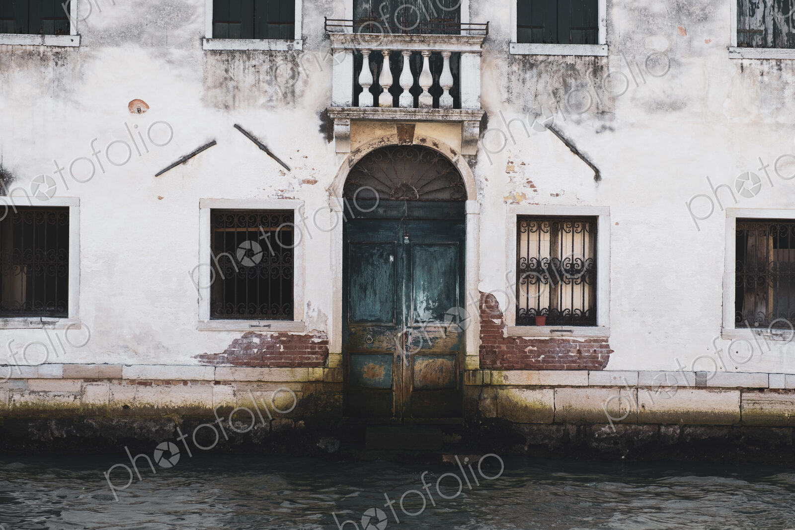 Exterior view of a neglected building on the Canale Grande in Venice, Veneto, Italy.
