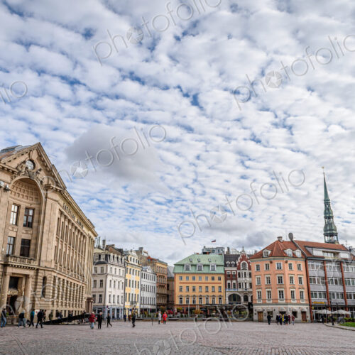Exterior view of historic buildings in Riga, in a city square under a dramatic cloudy sky. Exterior view of historic buildings in Riga, in a city square under a dramatic cloudy sky.