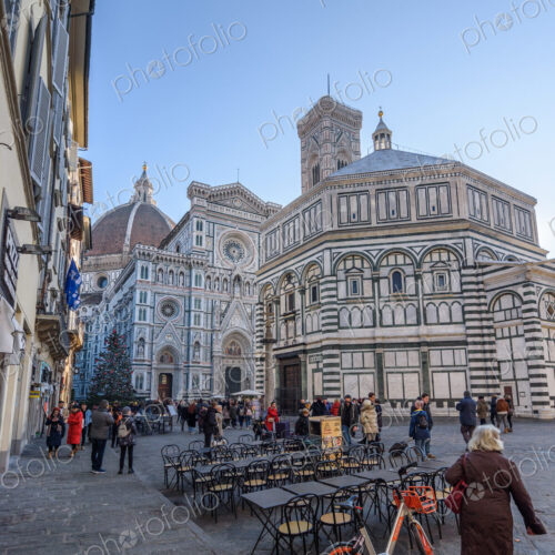Exterior view of the Baptistery of St. John in Florence, people in the square below. Exterior view of the Baptistery of St. John in Florence, people in the square below.