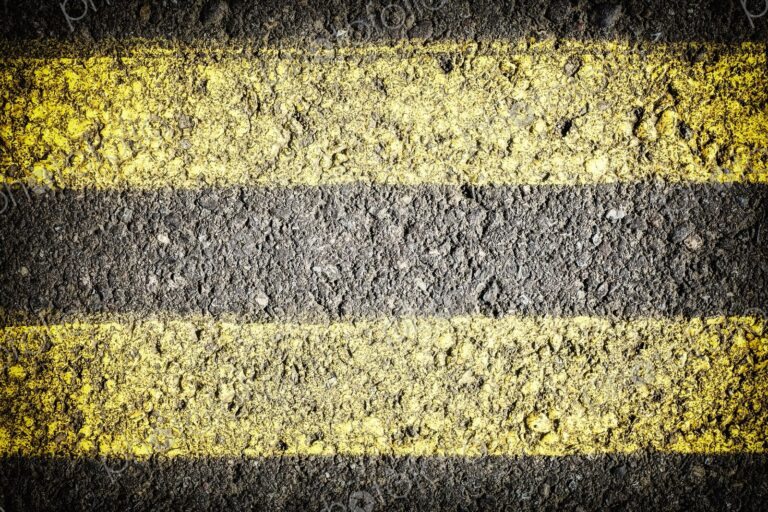 Extreme closeup of double yellow lines painted on the roadway
