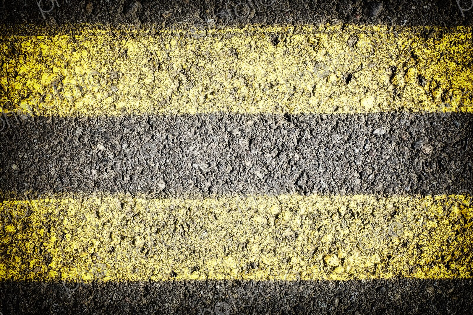 Extreme closeup of double yellow lines painted on the roadway