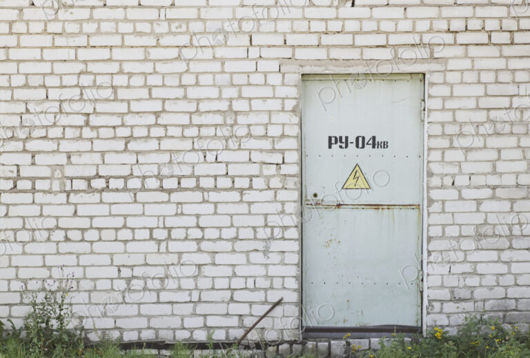 Factory Entrance With a Warning Sign