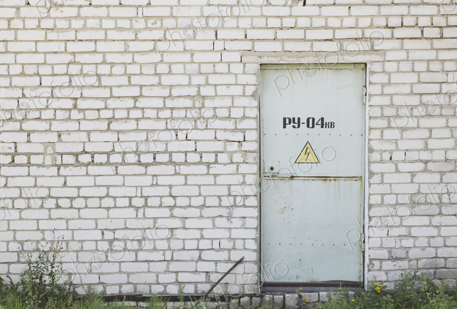 Factory Entrance With a Warning Sign