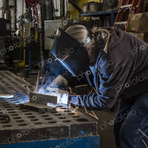 Factory worker using Oxyacetylene gas to weld two piece of metal in a sheet metal factory