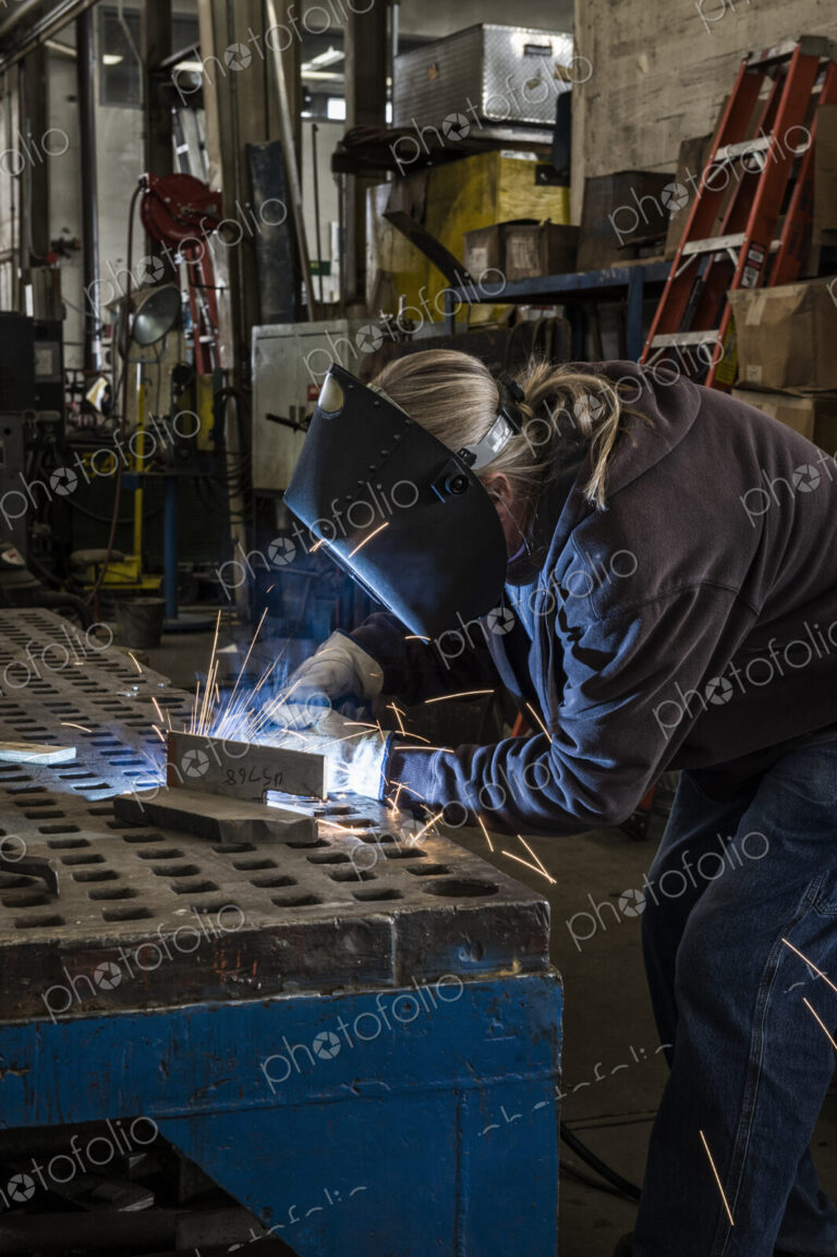 Factory worker using Oxyacetylene gas to weld two piece of metal in a sheet metal factory