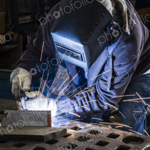 Factory worker using Oxyacetylene gas to weld two piece of metal in a sheet metal factory