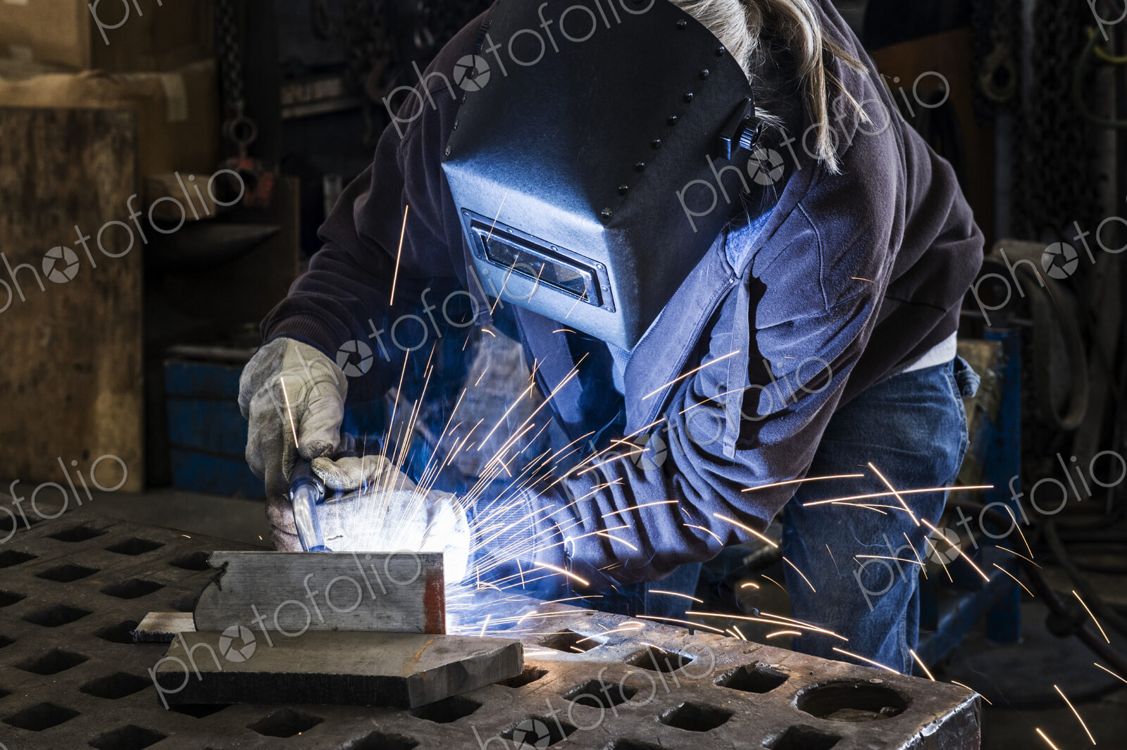 Factory worker using Oxyacetylene gas to weld two piece of metal in a sheet metal factory