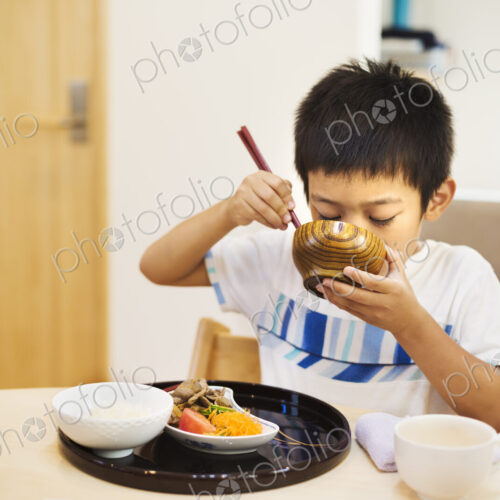 Family home. A boy eating a meal. Family home. A boy eating a meal.
