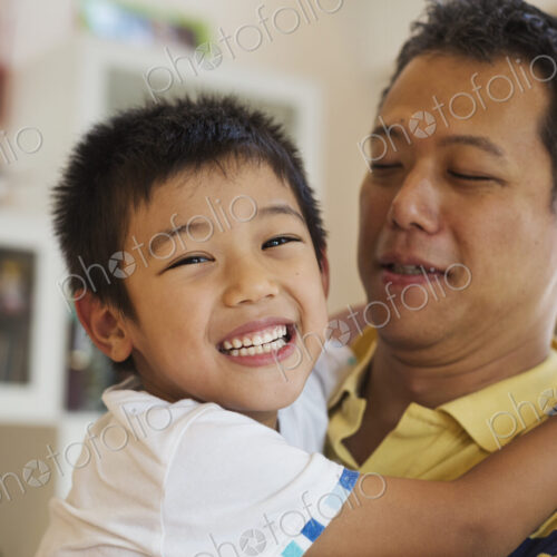 Family home. A man holding his son. Family home. A man holding his son.