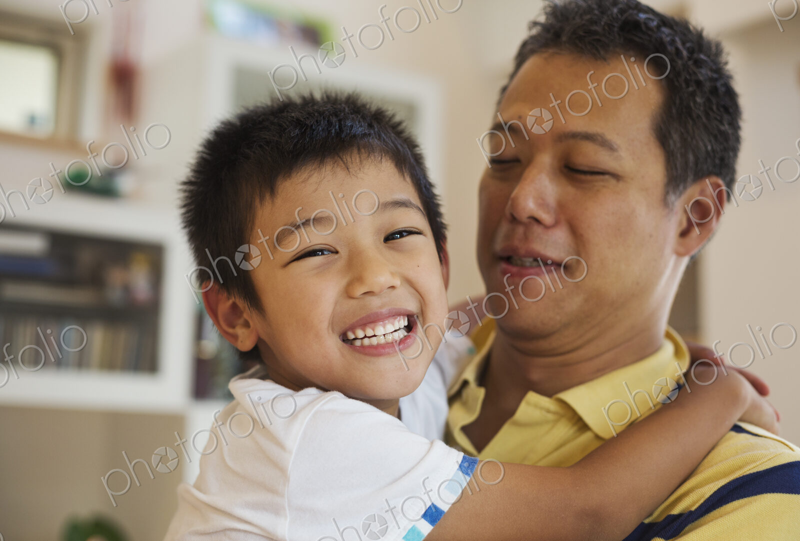 Family home. A man holding his son.
