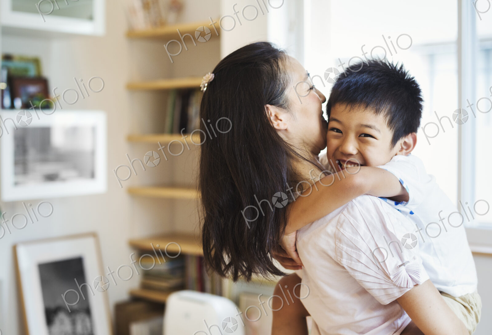 Family home. A mother and her son cuddling.