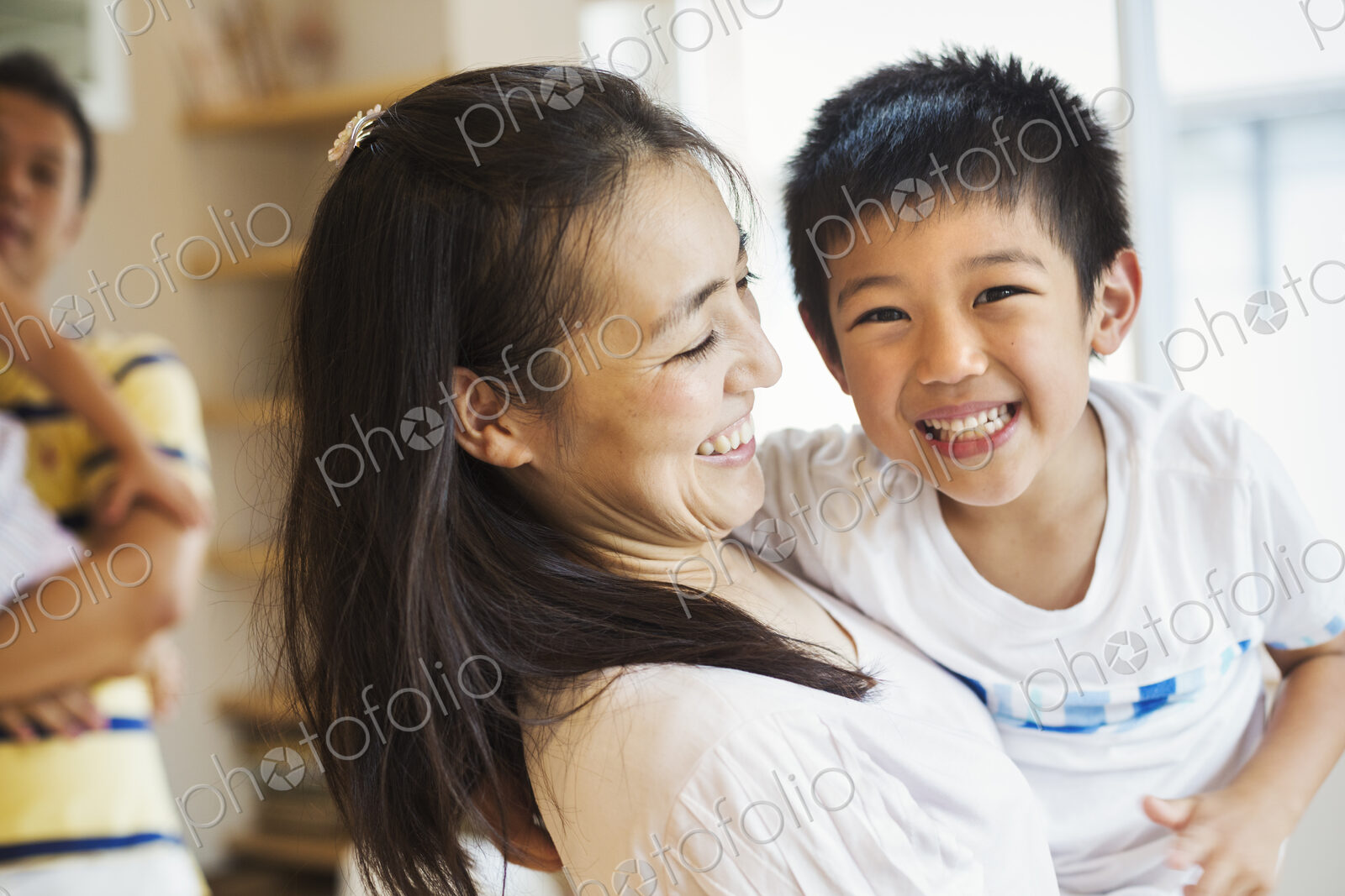 Family home. A mother holding her son, and a father holding his daughter.
