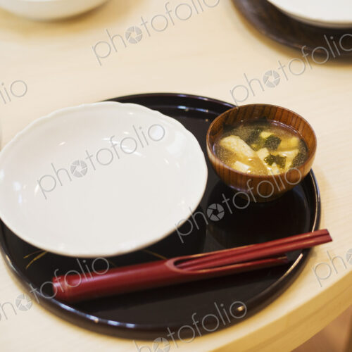 Family home. A table place set for a meal. Mat, bowl and chopsticks. Family home. A table place set for a meal. Mat, bowl and chopsticks.