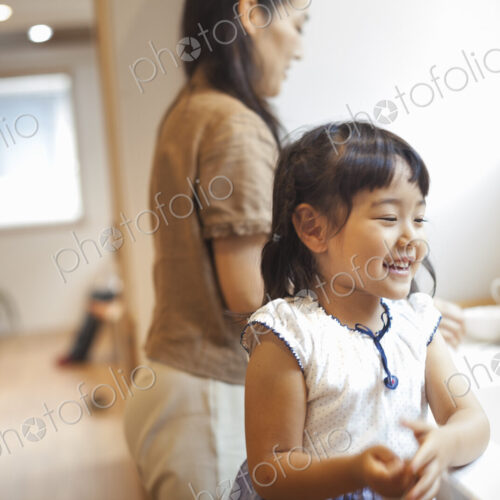 Family home. A woman and a girl in the kitchen. Family home. A woman and a girl in the kitchen.