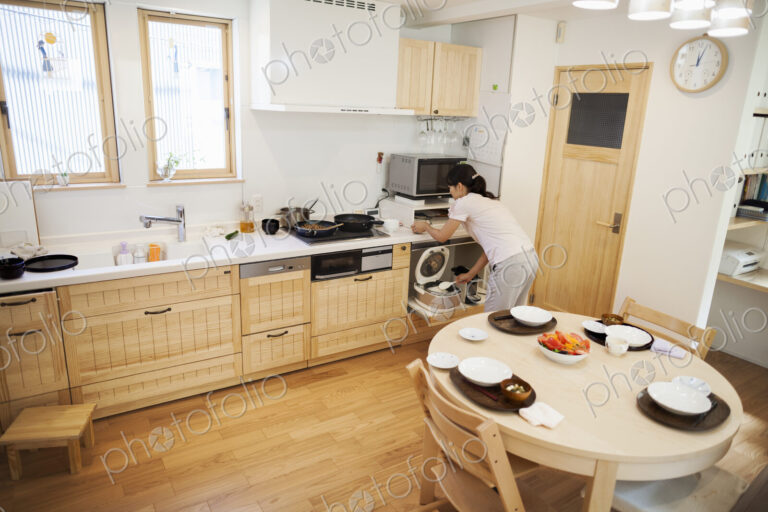 Family home. A woman preparing a meal in a kitchen.