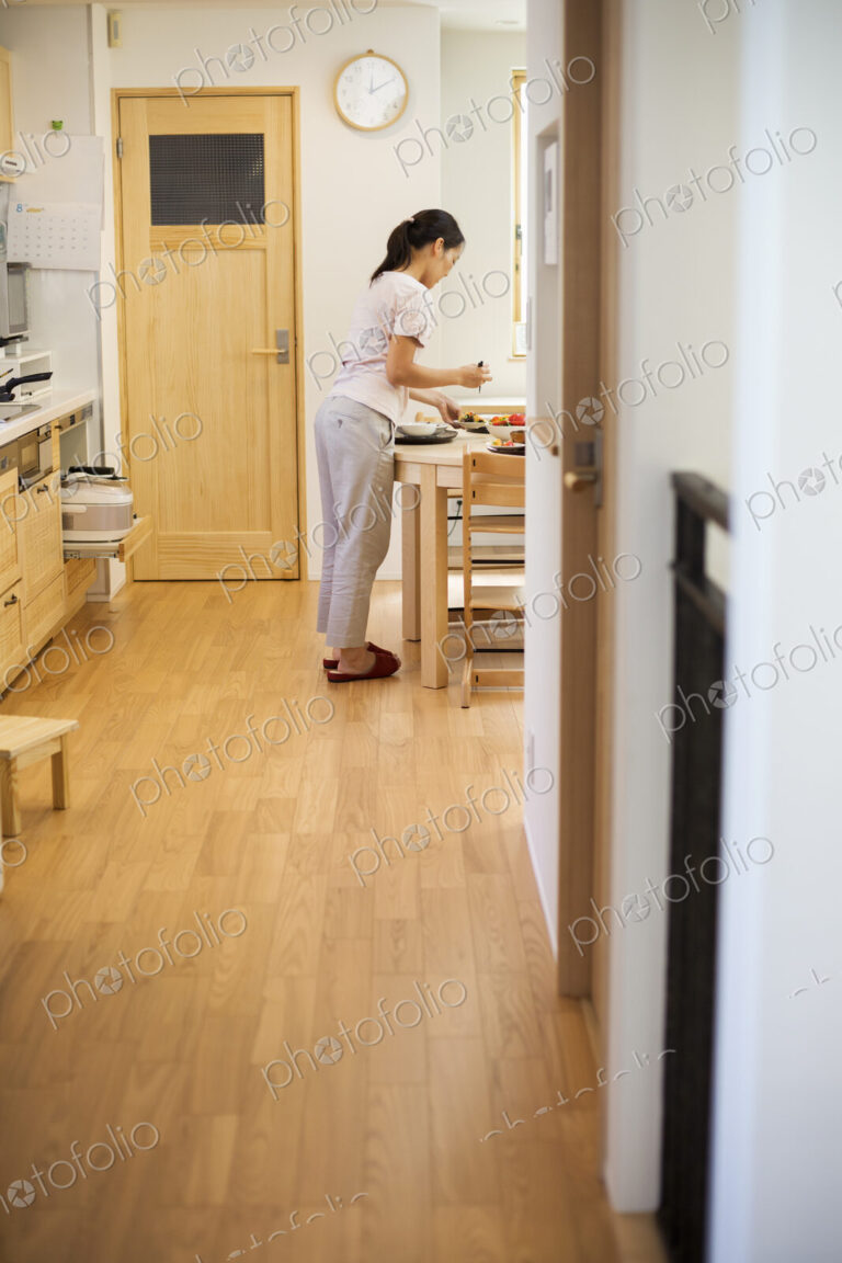 Family home. A woman standing in a kitchen.