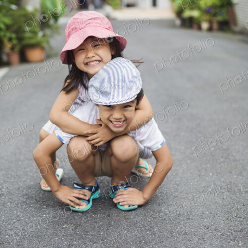 Family home. Two children, a boy and girl playing outdoors.