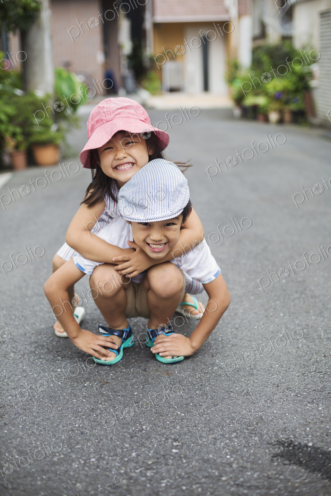 Family home. Two children, a boy and girl playing outdoors.